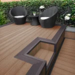 Brown composite decking with step and wicker chairs.