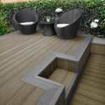 Composite decking with step and wicker chairs.
