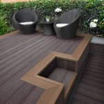 Dark composite decking with light brown step and chairs.