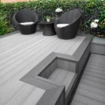Grey composite decking with darker grey step and chairs.