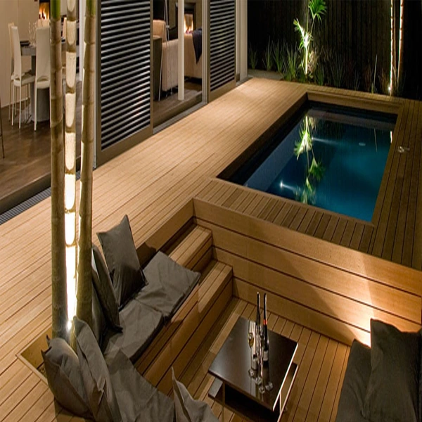 Light blonde wood decking surrounding a small outdoor pool.