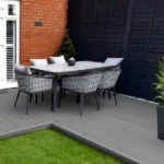 Outdoor dining set on grey composite decking.