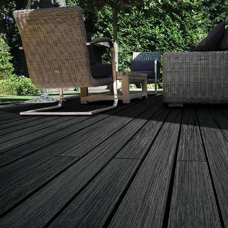 charcoal WPC decking under wicker and wooden patio chairs.